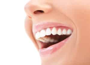 Close up image of someone's smiling mouth after TMJ treatment