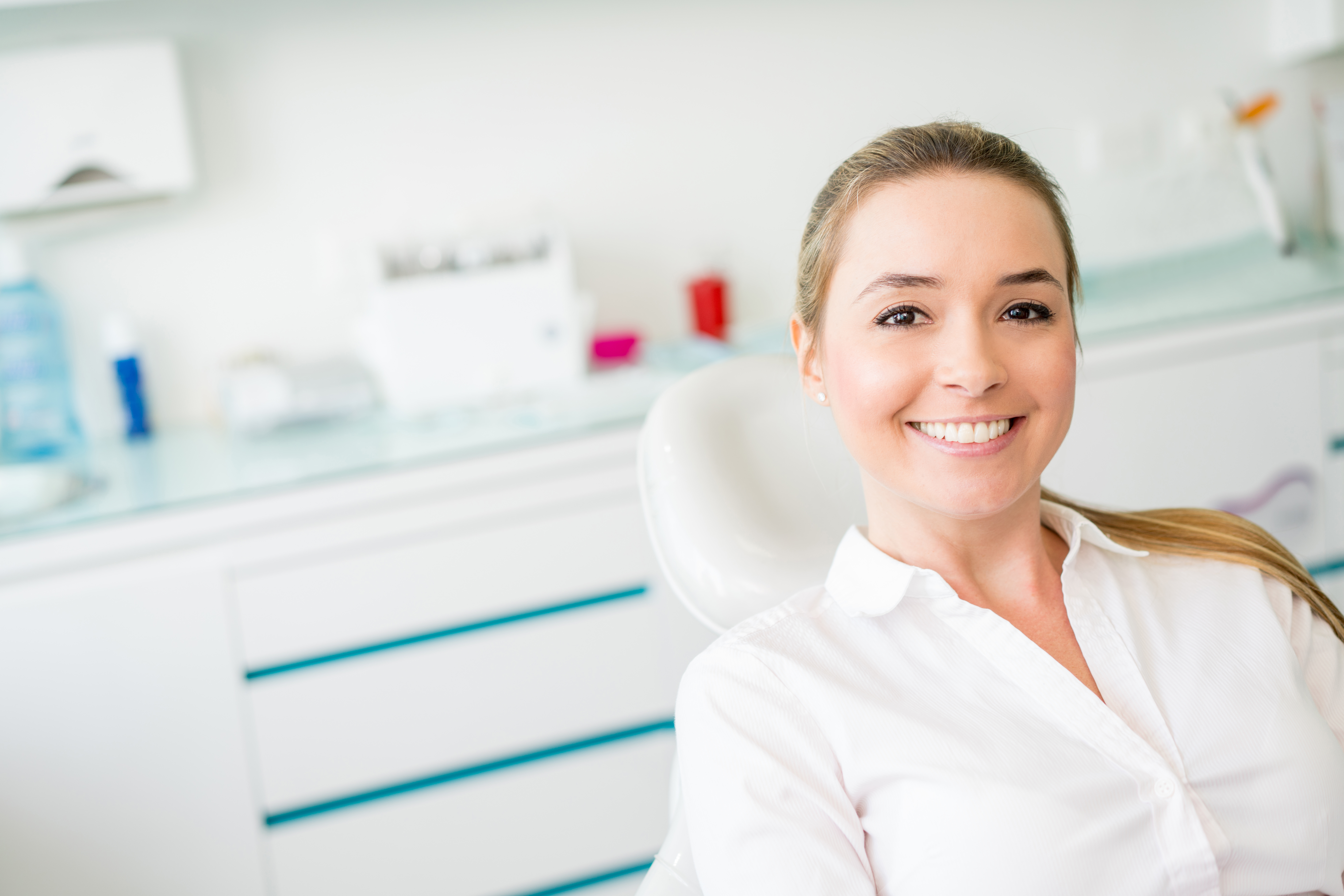 Woman sitting in dental operating room smiling