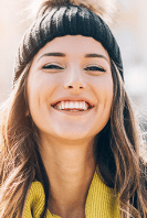 woman with beanie smiling big