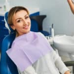 Woman-in-a-dental-office-having-a-seat-in-a-medical-chair