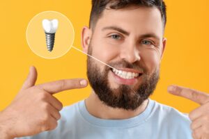 Dental implant diagram shows man who is happy with a complete smile
