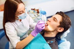 Male patient undergoes a routine dental cleaning as part of preventative care.