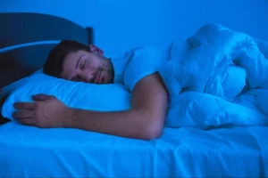 Man sleeps comfortably in his bed without excess snoring.