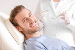 Man in his 30s has his teeth examined by a qualified dentist.