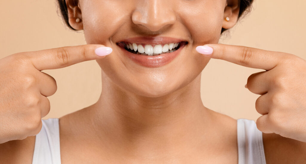 Pretty Latina woman with nice white veneers shows off her improved smile.